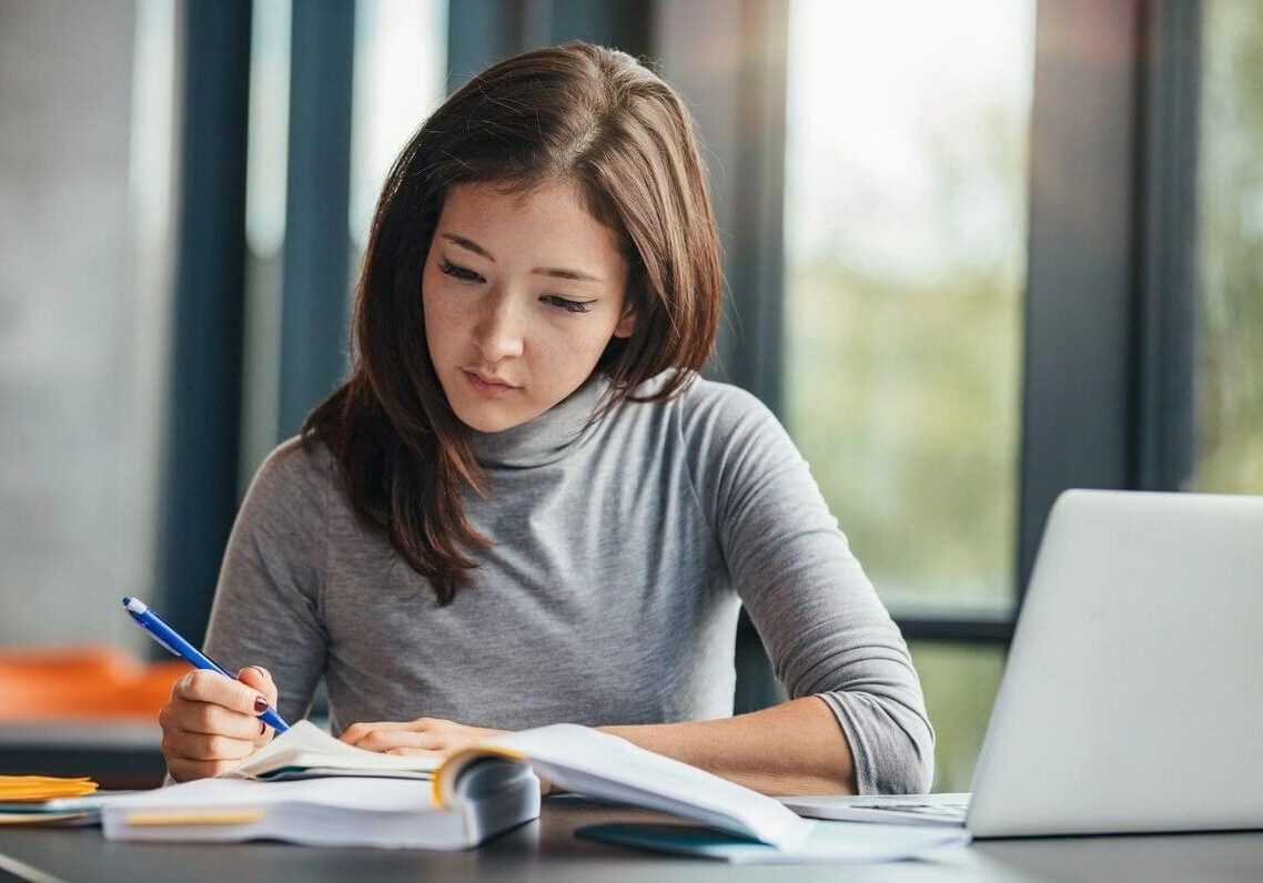 Woman taking down notes in diary